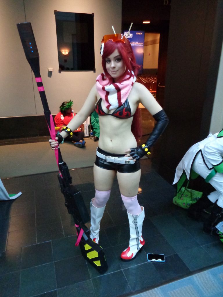 bikini bikini_top_only breasts cleavage cosplay gun looking_at_viewer midriff navel photo_(medium) red_hair rifle short_shorts shorts smile sniper_rifle swimsuit tengen_toppa_gurren_lagann weapon yoko_littner yoko_littner_(cosplay)