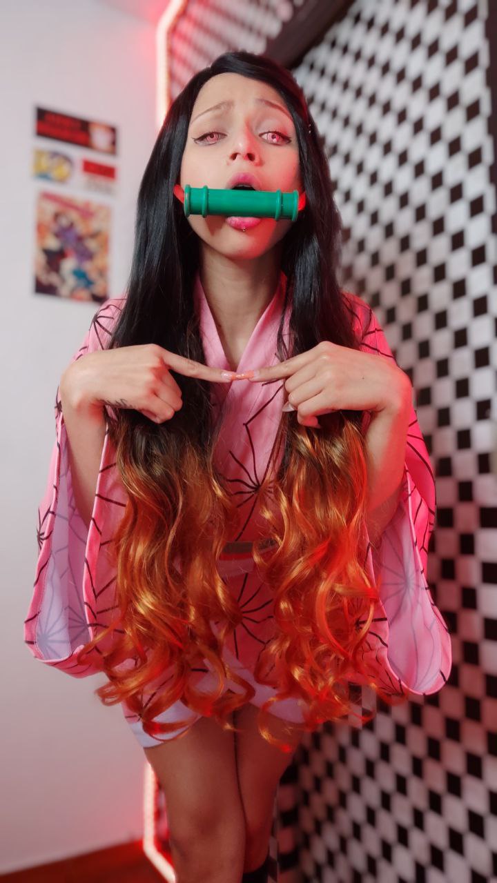 1girl ahegao bamboo bare_legs black_hair blurry blurry_background cosplay female_focus fingers_together firegirlplay highres indoors japanese_clothes kamado_nezuko kamado_nezuko_(cosplay) kimetsu_no_yaiba kimono looking_at_viewer multicolored_hair open_mouth orange_hair photo_(medium) pink_eyes pink_kimono solo standing venezuelan_(nationality)