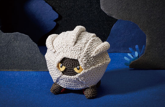 amigurumi_(medium) asako_ito cave commentary creature english_commentary gen_3_pokemon nature nintendo no_humans photo_(medium) pokemon pokemon_(creature) pokemon_tcg shadow shelgon solo standing third-party_source unconventional_media yellow_eyes