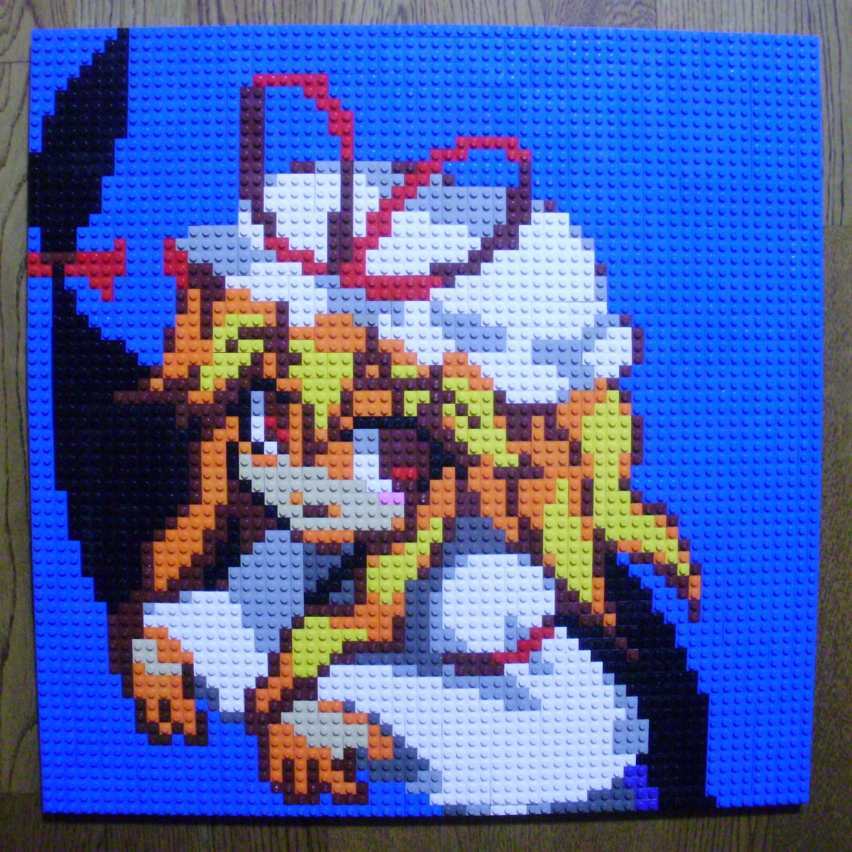 1girl blonde_hair female_focus gap_(touhou) hat highres lego lego_(medium) photo_(medium) pixel_art red_eyes simple_background smile solo table touhou unconventional_media yakumo_yukari you_rei_(blowback)