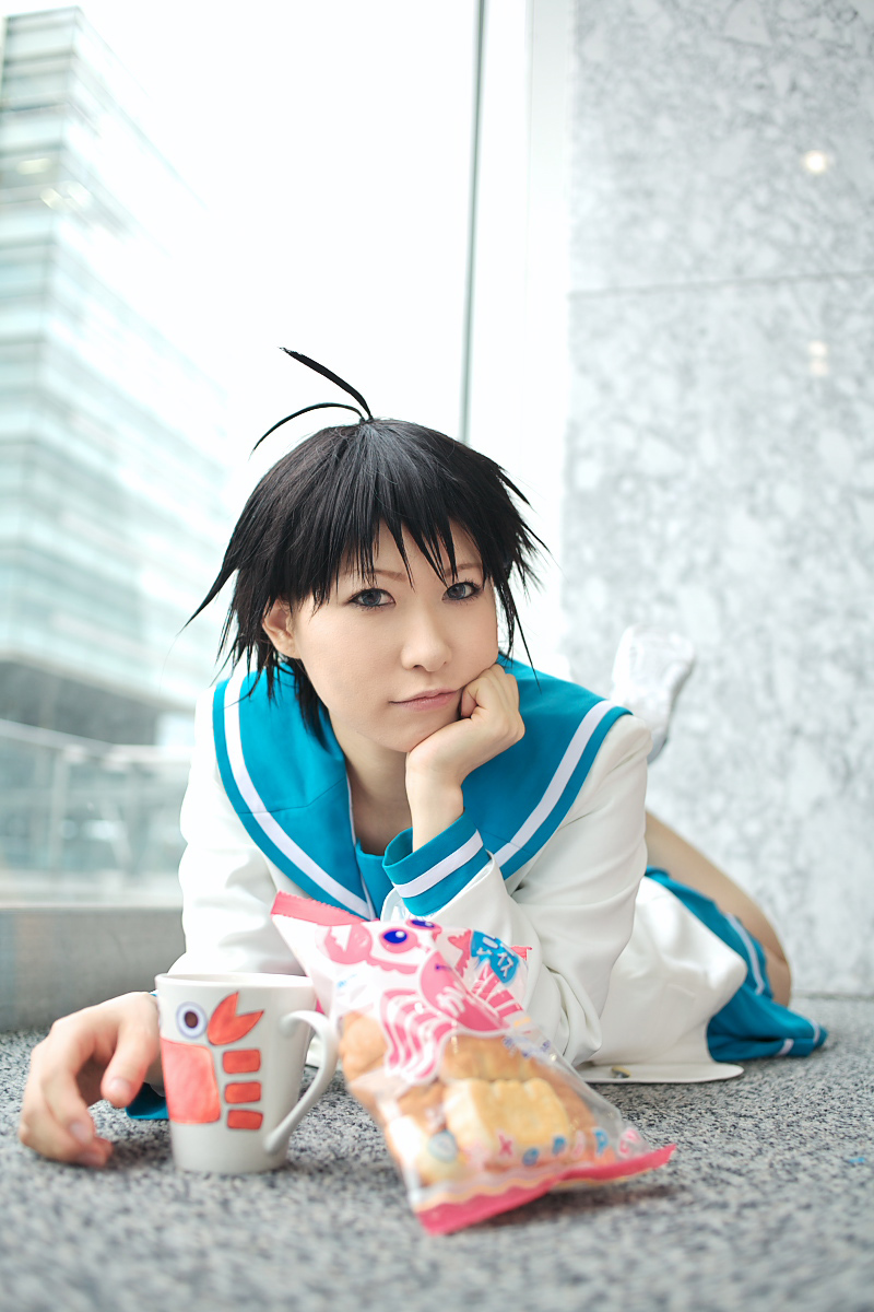 1girl ahoge asian blue_eyes chippi coffee_mug color_contacts cosplay crab crab_crackers cup female_focus highres idolmaster idolmaster_xenoglossia indoors kikuchi_makoto kikuchi_makoto_(cosplay) looking_at_viewer lying mug on_stomach photo_(medium) school_uniform serafuku short_hair solo