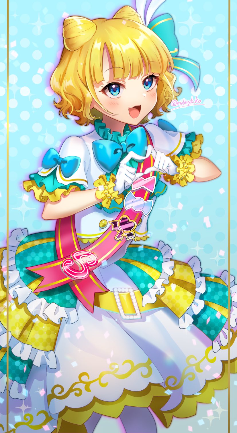 1girl :d blonde_hair blue_background blue_eyes blunt_bangs blush cone_hair_bun cowboy_shot double_bun frilled_skirt frills gloves hair_bun heart heart_hands highres idol_clothes jacket looking_at_viewer mendamen minami_mirei open_mouth pink_sash polka_dot polka_dot_background pretty_series pripara sash short_hair short_sleeves skirt smile solo standing white_gloves white_jacket white_skirt