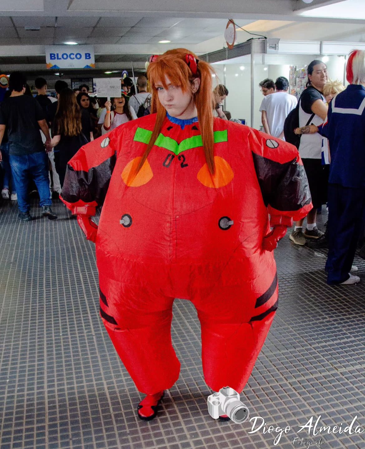 1girl 6+others alternate_costume alternate_form blue_eyes bodysuit brazilian_(nationality) brown_hair cheek_bulge cosplay hand_on_own_hip hands_on_own_hips highres inflation interface_headset_(evangelion) lips mecha_pilot_suit memepantazis multiple_boys multiple_girls multiple_others neon_genesis_evangelion ok_sign photo_(medium) plugsuit_(evangelion) red_bodysuit shiny_clothes smile solo souryuu_asuka_langley souryuu_asuka_langley_(cosplay) standing tsundere two_side_up
