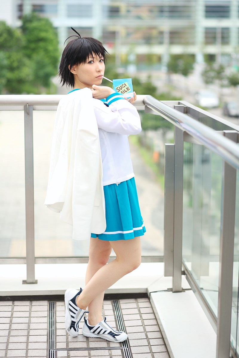 1girl ahoge asian black_hair blue_eyes chippi color_contacts cosplay drinking_straw female_focus highres idolmaster idolmaster_xenoglossia kikuchi_makoto kikuchi_makoto_(cosplay) looking_at_viewer milk milk_carton outdoors photo_(medium) school_uniform serafuku shoes short_hair sneakers solo