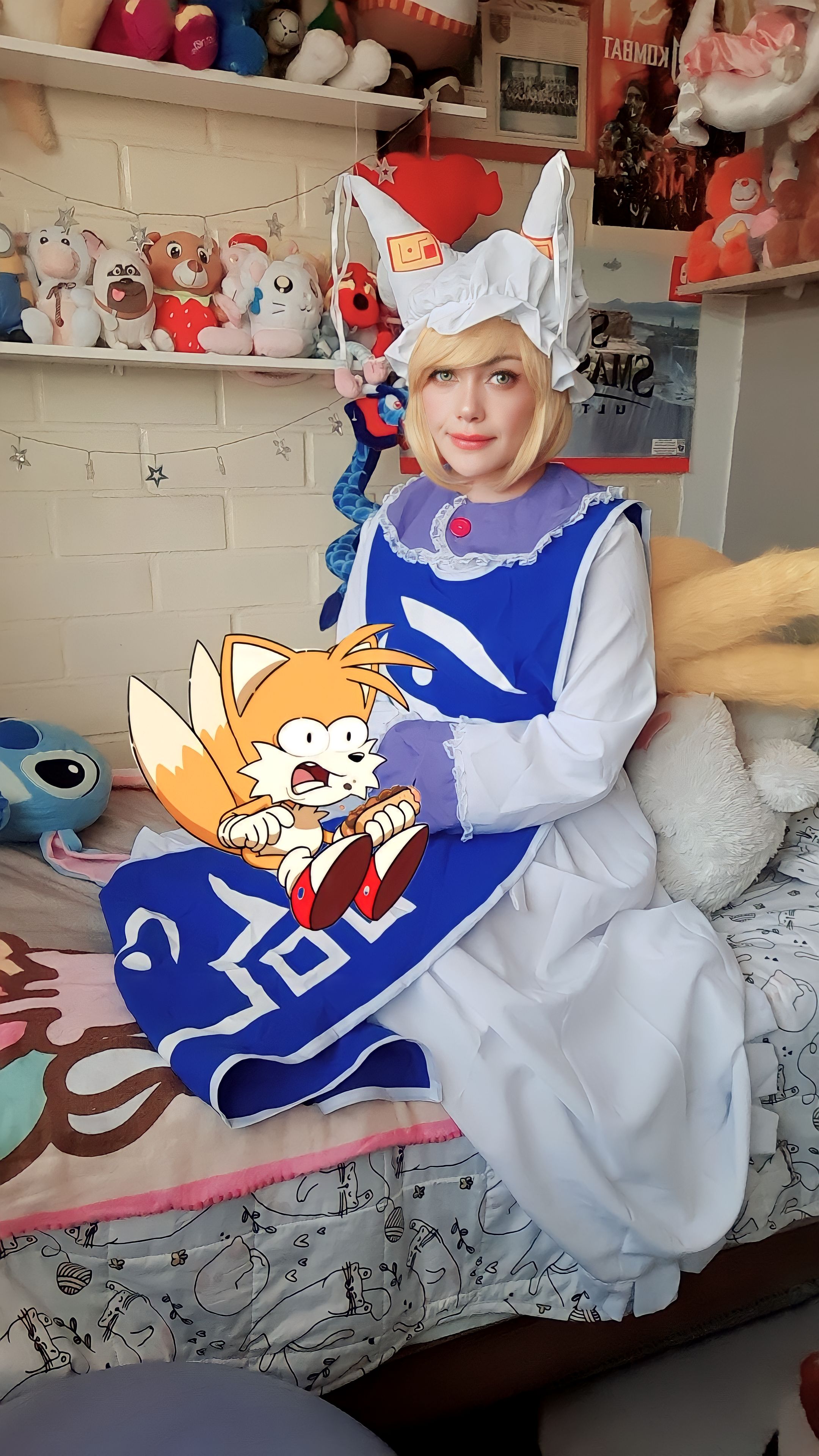 1girl absurdres bed blonde_hair chili_dog cosplay cosplay_photo fox fox_tail gen_1_pokemon highres kitsune kyuubi lilo_&amp;_stitch multiple_tails ninetales non-web_source on_bed photo_(medium) sonic_(series) stitch_(lilo_&amp;_stitch) stuffed_animal stuffed_toy tail tails_(sonic) touhou yakumo_ran yakumo_ran_(fox)