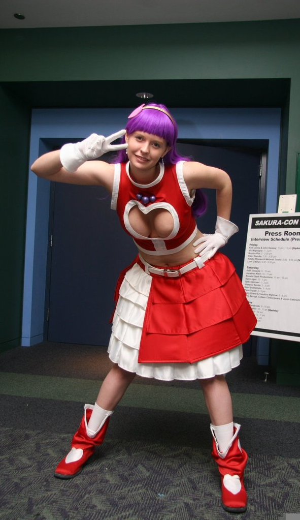 asamiya_athena asamiya_athena_(cosplay) breasts cleavage cosplay midriff navel nipple_slip nipples non-asian photo_(medium) purple_hair smile snk the_king_of_fighters the_king_of_fighters_2003