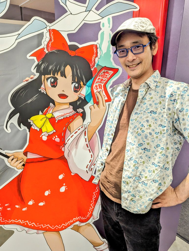 1boy 1girl ascot beret black_hair black_pants blue-framed_eyewear bow brown_eyes brown_shirt collared_shirt detached_sleeves frilled_ascot frilled_bow frilled_hair_tubes frilled_shirt_collar frilled_skirt frills glasses gohei hair_bow hair_tubes hakurei_reimu hands_on_own_hips hat holding holding_gohei indoors looking_at_viewer medium_hair open_clothes open_mouth open_shirt pants photo_(medium) print_shirt print_skirt real_life red_bow red_eyes red_ribbon red_shirt red_skirt ribbon ribbon-trimmed_sleeves ribbon_trim shirt short_hair skirt sleeveless sleeveless_shirt socks teeth touhou unfinished_dream_of_all_living_ghost upper_teeth_only very_short_hair white_socks wide_sleeves yellow_ascot zun