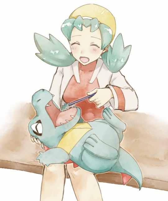1girl :d asuka_rkgk blush closed_eyes commentary flipped_hair gen_2_pokemon green_hair happy hat holding holding_toothbrush jacket kris_(pokemon) long_hair long_sleeves nintendo on_lap open_clothes open_jacket open_mouth pokemon pokemon_(creature) pokemon_gsc pokemon_on_lap red_shirt shirt sitting smile symbol-only_commentary toothbrush totodile twintails white_jacket yellow_hat