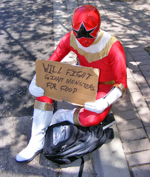 1boy backpack bag belt bodysuit boots chouriki_sentai_ohranger cosplay curb gloves gold_belt helmet holding holding_sign oh_red pavement photo_(medium) power_rangers power_rangers_zeo randoseru red_bodysuit road sidewalk sign sign_holding star_(symbol) super_sentai tokusatsu white_footwear white_gloves zeo_ranger_v_red