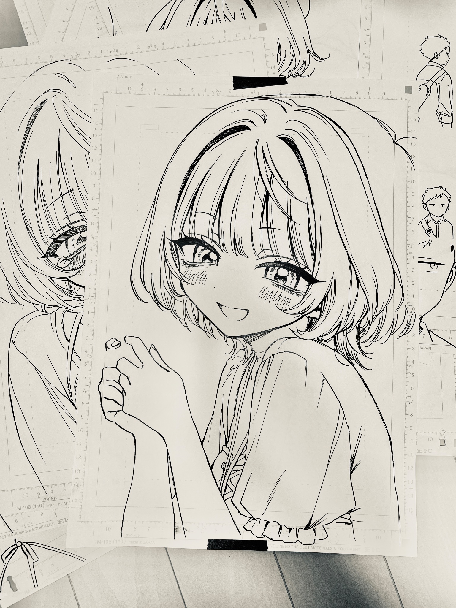 1girl :d akiyama_enma blush commentary_request greyscale hair_intakes highres lanyard looking_at_viewer manuscript_paper monochrome nib_pen_(medium) noa-senpai_wa_tomodachi. open_mouth pen_(medium) photo_(medium) puffy_short_sleeves puffy_sleeves saotome_noa shirt short_hair short_sleeves smile solo split_mouth traditional_media upper_body