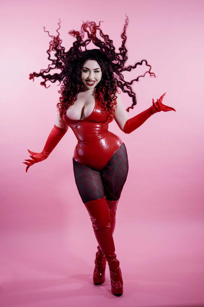 1girl black_eyeshadow blush_(makeup) boots breasts cartoon_network cleavage clenched_teeth collarbone cosplay cosplay_photo crossed_legs curly_hair elbow_gloves eyelashes eyeliner eyeshadow female_focus fishnets gloves green_eyes high_heels large_breasts latex latex_boots latex_gloves latex_legwear latex_leotard leotard lips lipstick long_hair makeup photo_(medium) pink_background platform_boots platform_footwear platform_heels powerpuff_girls red_boots red_gloves red_hair red_leotard red_lips red_thighhighs sedusa sedusa_(cosplay) shadow smile solo standing tagme teeth thejulietttemichele thick_thighs thighhighs thighs wide_hips wig