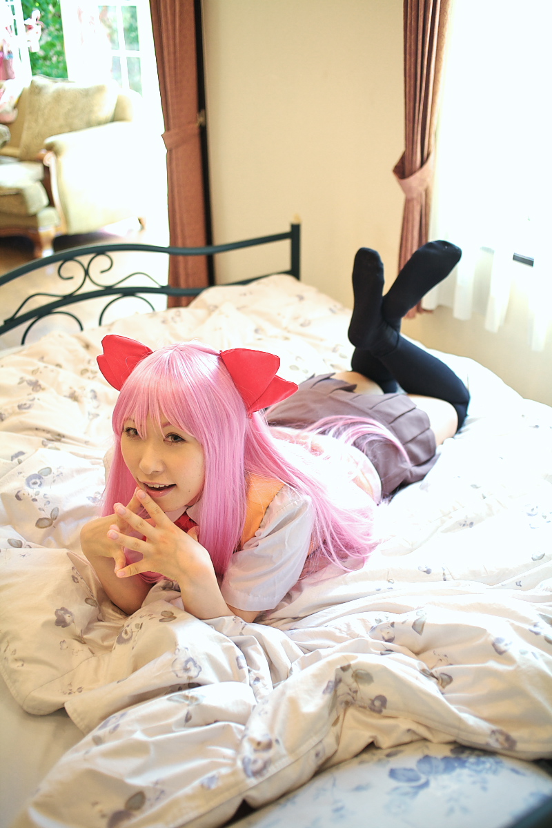 1girl asian bed bedroom black_thighhighs chippi color_contacts cosplay feet female_focus highres indoors long_hair looking_at_viewer lying munakata_shiho munakata_shiho_(cosplay) my-hime on_stomach photo_(medium) pink_hair school_uniform solo thighhighs