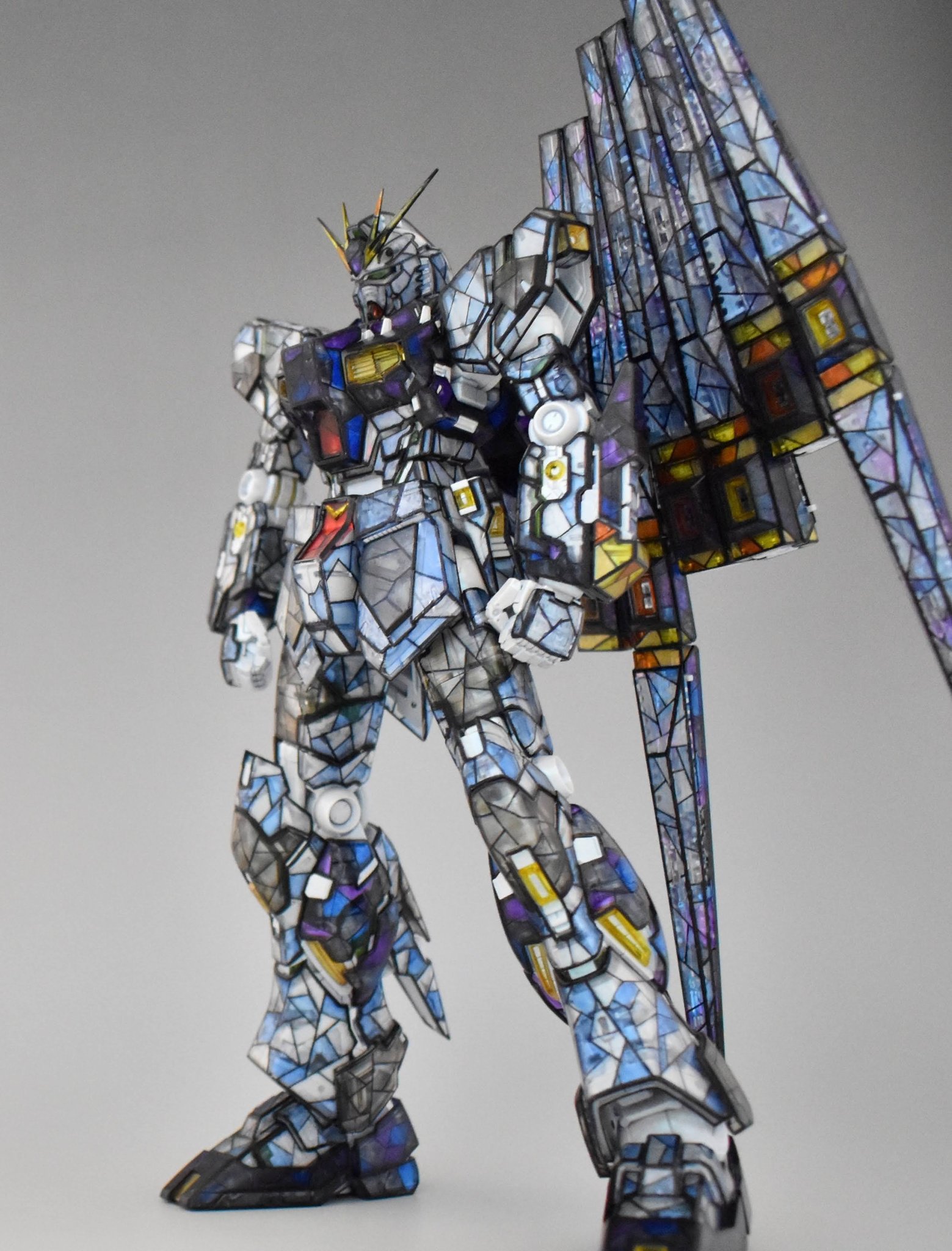 char&#039;s_counterattack clenched_hands fin_funnels gundam gunpla highres looking_down mecha mobile_suit model_kit model_kit_(medium) no_humans nu_gundam photo_(medium) robot science_fiction solo stained_glass standing sui_(sui4121) unconventional_media v-fin
