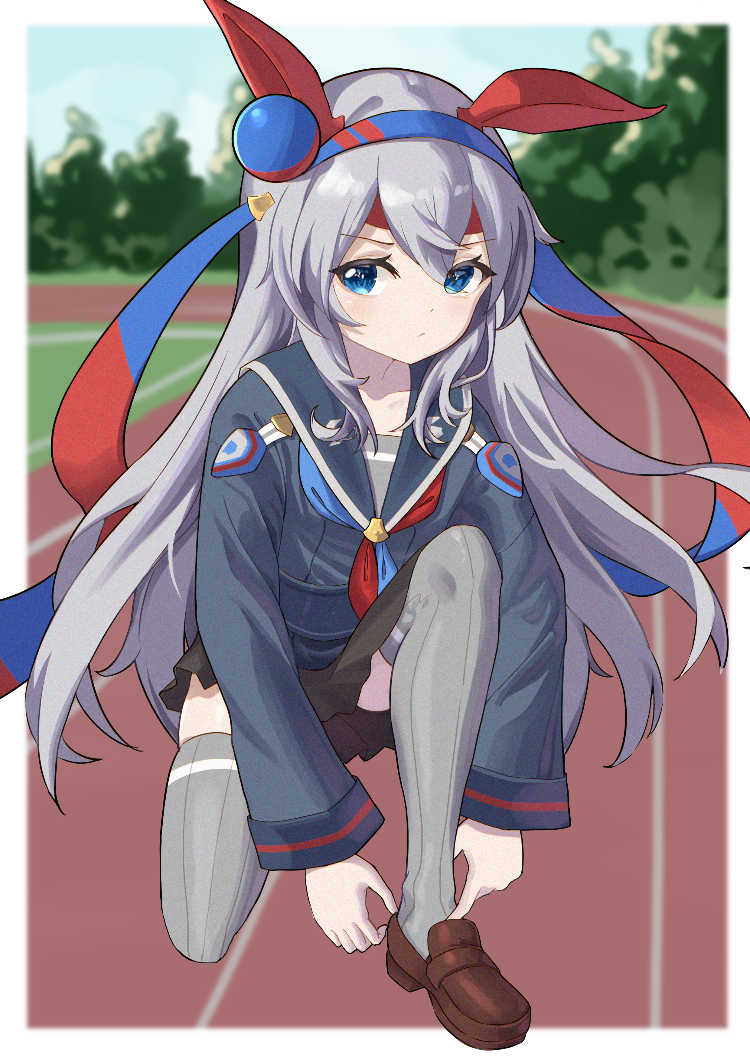 1girl absurdres adjusting_footwear animal_ears black_skirt blue_hairband blue_neckerchief blurry blurry_background brown_shoes chinese_commentary commentary_request depth_of_field ear_covers grey_hair grey_sailor_collar grey_shirt grey_thighhighs hair_between_eyes hairband headband highres horse_ears kneeling loafers long_hair long_sidelocks looking_at_viewer miniskirt neckerchief no_tail official_alternate_costume outdoors parted_bangs racetrack red_headband red_neckerchief ribbed_thighhighs sailor_collar school_uniform senbonsang serafuku shirt shoes sidelocks skirt solo tamamo_cross_(umamusume) thighhighs two-tone_neckerchief umamusume very_long_hair