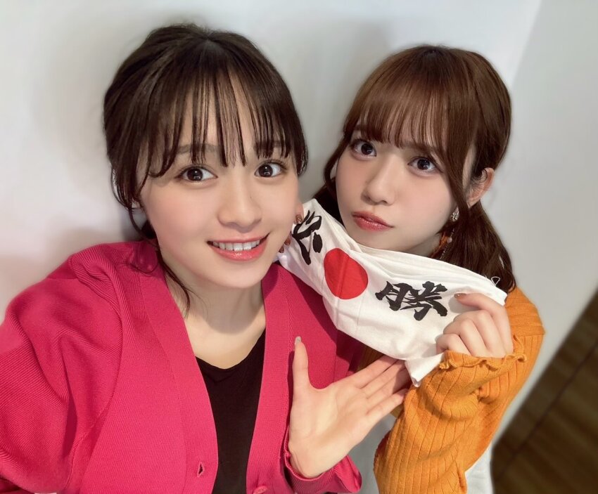 2girls date_sayuri emori_aya indoors looking_at_viewer multiple_girls photo_(medium) selfie simple_background smile standing