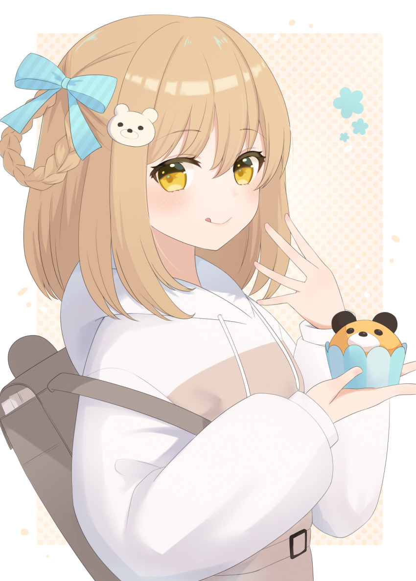 1girl bear_hair_ornament blue_ribbon border braid brown_hair closed_mouth cupcake drawstring food furutori grey_bag hair_ornament hair_ribbon highres holding holding_food hood hood_down hoodie licking_lips long_sleeves looking_at_viewer original polka_dot polka_dot_background ribbon short_hair sidelocks simple_background smile solo tongue tongue_out upper_body white_border white_hoodie yellow_background yellow_eyes