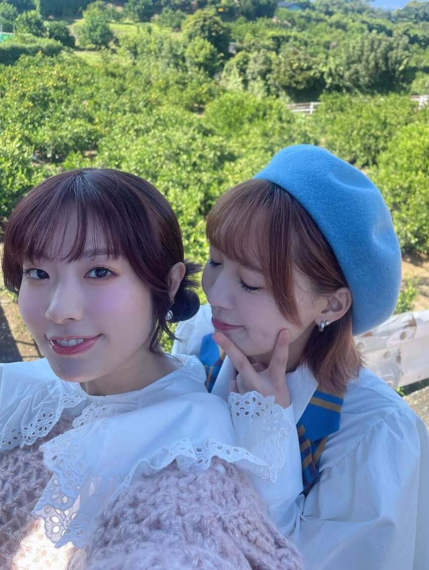 2girls blurry earrings furihata_ai highres japanese_(nationality) jewelry looking_at_viewer multiple_girls outdoors photo_(medium) real_life saito_shuka selfie short_hair tree voice_actor