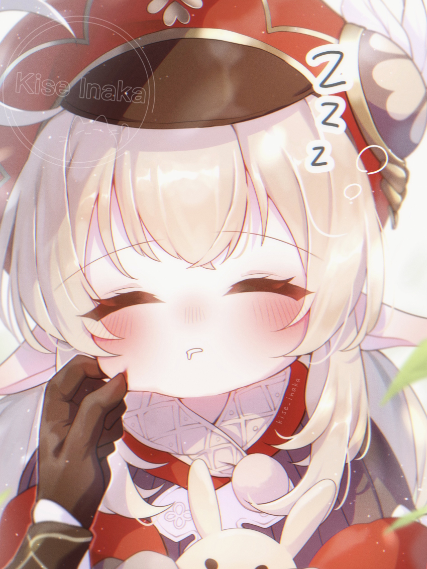 1boy 1girl absurdres aether_(genshin_impact) ahoge black_gloves blonde_hair blush cheek_pinching closed_eyes commentary_request dodoco_(genshin_impact) genshin_impact gloves hat highres kise_inaka klee_(genshin_impact) long_hair out_of_frame pinching pointy_ears red_hat sleeping solo_focus squeans twitter_username upper_body zzz