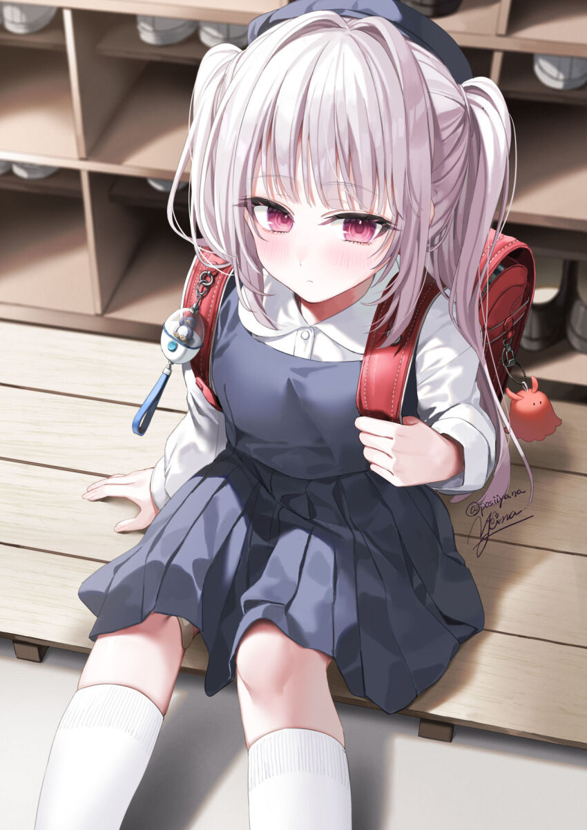 1girl backpack bag bag_charm charm_(object) crime_prevention_buzzer dress grey_dress grey_hair hat highres long_hair looking_at_viewer original pleated_dress randoseru red_bag red_eyes school_hat shirt sitting solo twintails white_shirt yana_mori