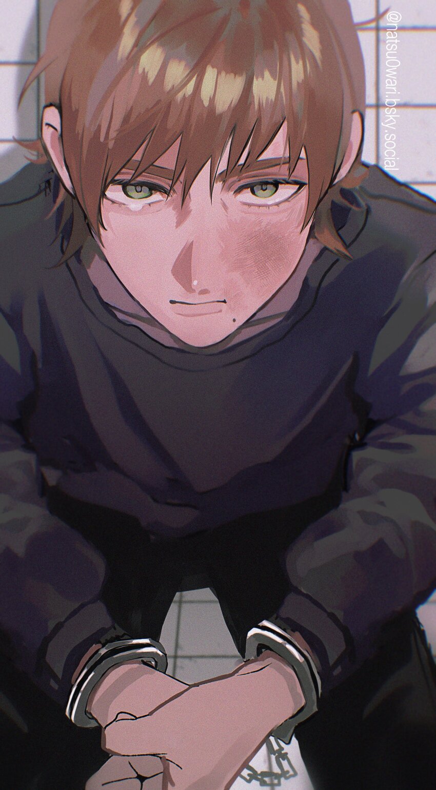 1boy absurdres brown_hair bruise bruise_on_face cuffs green_eyes grid_background gundam gundam_gquuuuuux handcuffs highres injury long_sleeves looking_at_viewer male_focus mole mole_under_mouth natsu0wari shirt short_hair solo tearing_up turtleneck xavier_olivette