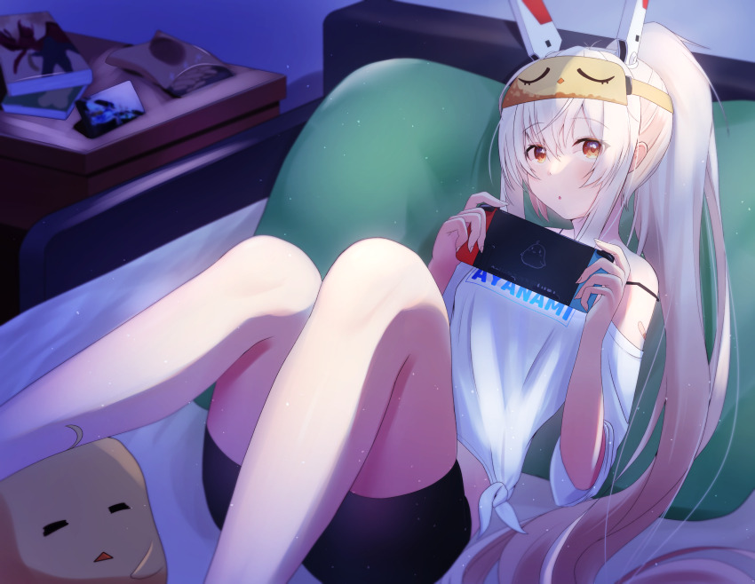 1girl ayanami_(azur_lane) ayanami_(off-duty_battle_station_gear)_(azur_lane) azur_lane bed black_shorts character_name clothes_writing hair_between_eyes headgear highres long_hair lying manjuu_(azur_lane) nintendo_switch off_shoulder on_back on_bed orange_eyes pillow ponytail shorts sleep_mask solo tako-san_wiener_(takosanuma) white_hair