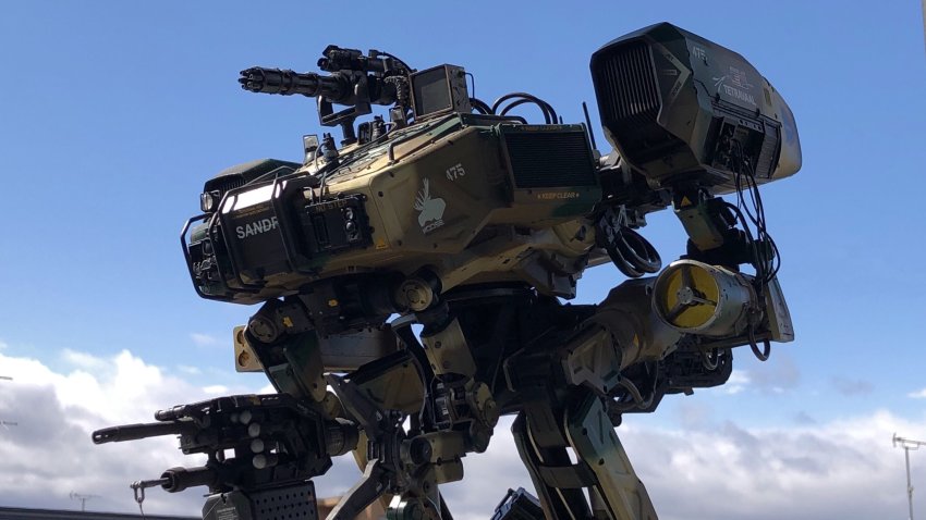 bad_id bad_twitter_id camouflage chappie cloud from_side gatling_gun highres looking_ahead mecha model_kit model_kit_(medium) moose_(chappie) no_humans photo_(medium) photorealistic realistic robot science_fiction sky solo turret unconventional_media