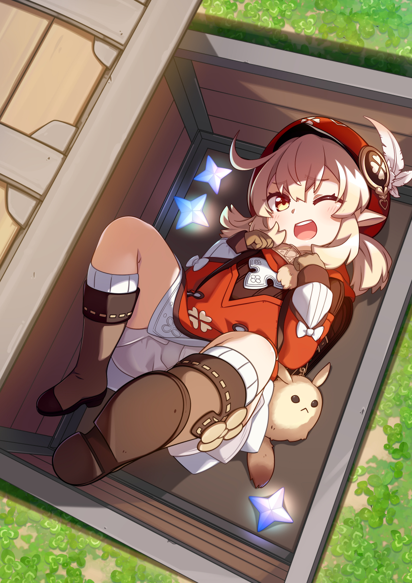 1girl absurdres ahoge backpack bag bag_charm blonde_hair bloomers blush boots box brown_boots brown_gloves newsboy_cap charm_(object) clover_print coat coin_hair_ornament commentary dress feathers fuu_(koneko_no_yomeiri) genshin_impact gloves grass hair_between_eyes hair_ornament hat hat_feather hat_ornament highres in_box in_container klee_(genshin_impact) knee_boots long_hair long_sleeves looking_at_viewer low_twintails lying on_back open_mouth outdoors pointy_ears primogem randoseru red_coat red_eyes red_hat sidelocks solo teeth treasure_chest twintails underwear upper_teeth_only white_feathers