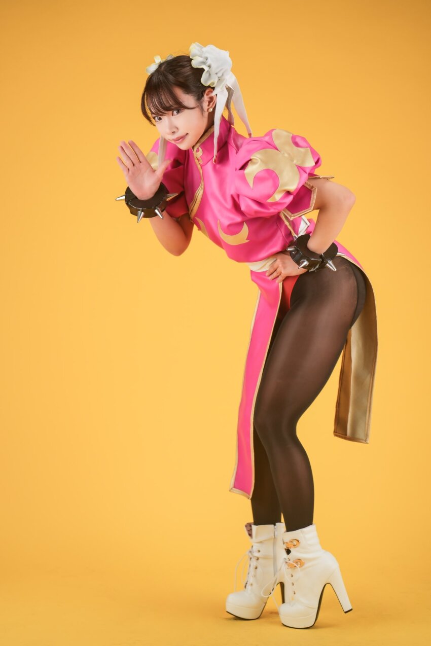 1girl ankle_boots asian ass boots bracelet bun_cover capcom chinese_clothes chun-li cosplay cosplay_photo dress full_body hair_bun high_heel_boots high_heels highres jewelry legs looking_at_viewer pantyhose photo_(medium) pink_dress puffy_short_sleeves puffy_sleeves purin_cosplay short_sleeves spiked_bracelet spikes street_fighter waving white_boots