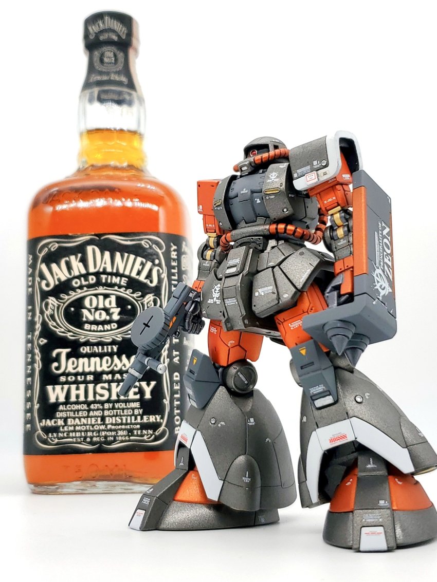 absurdres alcohol gun gundam gunpla highres holding holding_gun holding_weapon jack_daniel&#039;s looking_ahead mecha mj_(matsujun24) mobile_suit mobile_suit_gundam model_kit model_kit_(medium) one-eyed photo_(medium) red_eyes robot solo spikes unconventional_media weapon whiskey zaku_ii zeon