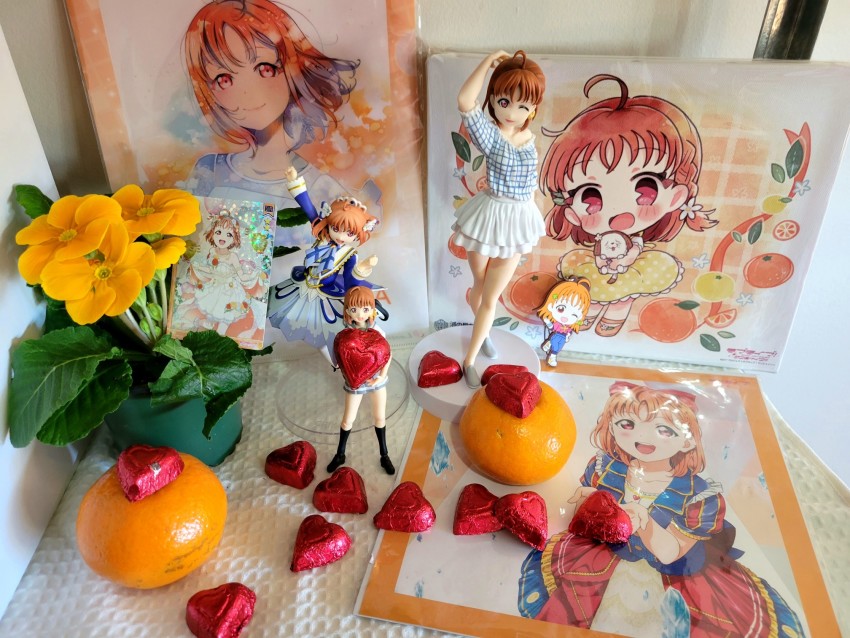 1girl 2d_dating ahoge black_socks blouse blue_coat braid candy chibi chocolate chocolate_heart coat collarbone commentary contrapposto crown_braid dress english_commentary figma figure flower food fruit heart highres holding holding_candy holding_chocolate holding_food kneehighs looking_at_viewer love_live! matching_hair/eyes medium_hair no_legwear official_alternate_costume one_eye_closed orange_(fruit) orange_eyes orange_flower orange_hair photo_(medium) photo_(object) plaid_clothes plaid_shirt plaid_skirt plant post potted_plant shirt short_sleeves skirt socks takami_chika tareme trading_card valentine white_dress white_shirt white_skirt