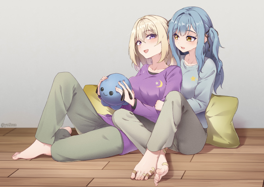 2girls absurdres bandaid bandaid_on_foot bang_dream! bang_dream!_it&#039;s_mygo!!!!! barefoot black_ribbon blonde_hair blue_hair blue_shirt commentary green_pants grey_pants hair_ribbon highres long_hair long_sleeves medium_hair misumi_uika multiple_girls on_floor open_mouth pants pillow purple_eyes purple_shirt ribbon shirt sitting smile stuffed_animal stuffed_octopus stuffed_toy toes togawa_sakiko two_side_up yellow_eyes yuri yzlkun