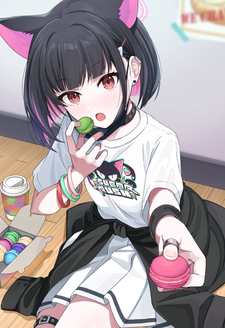 1girl :o animal_ears black_choker black_hair black_jacket blue_archive blurry blurry_background cat_ears cat_girl choker clothes_around_waist colored_inner_hair commentary_request earclip eating extra_ears food highres holding holding_food incoming_food indoors jacket jacket_around_waist jewelry kazusa_(band)_(blue_archive) kazusa_(blue_archive) looking_at_viewer macaron mask mask_pull miniskirt mouth_mask multicolored_hair official_alternate_costume on_floor open_mouth partial_commentary pastry_box pink_hair pleated_skirt red_eyes ring shirousagi_una shirt short_hair sitting skirt solo t-shirt thigh_strap white_shirt white_skirt wooden_floor wristband yokozuwari