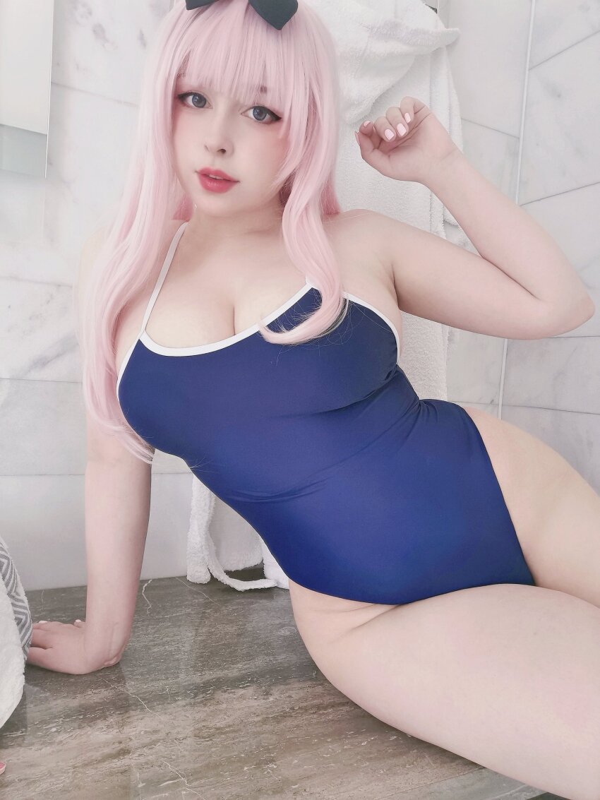 1girl armpits arms_behind_head bathroom blue_eyes breasts cleavage cosplay cosplay_photo fujiwara_chika fujiwara_chika_(cosplay) highres kaguya-sama_wa_kokurasetai_~tensai-tachi_no_renai_zunousen~ large_breasts long_hair looking_at_viewer one-piece_swimsuit photo_(medium) pink_hair real_life sleeveless smile swimsuit yoshinobi_cos