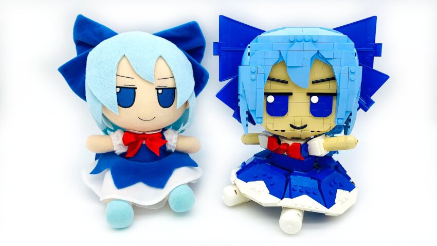 1girl blue_bow blue_dress blue_eyes blue_hair bow bowtie cirno closed_mouth commentary dress english_commentary frilled_sleeves frills full_body fumo_(doll) hair_bow highres lavishlump lego lego_(medium) looking_at_viewer no_humans pinafore_dress puffy_short_sleeves puffy_sleeves red_bow red_bowtie shirt short_sleeves simple_background sleeveless sleeveless_dress solo touhou unconventional_media white_background white_shirt