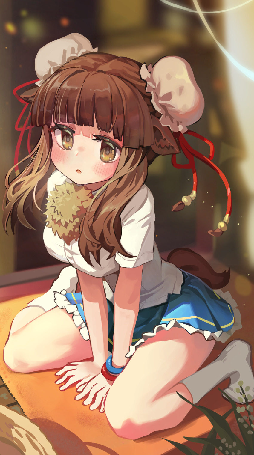 1girl absurdres animal_ear_fluff animal_ears bactrian_camel_(kemono_friends) bare_arms bare_legs between_legs blue_skirt blunt_bangs blurry blurry_background blush breasts brown_eyes brown_hair bun_cover commentary double_bun frilled_skirt frills full_body hair_bun hand_between_legs highres indoors kemono_friends long_hair looking_at_viewer medium_breasts melaton no_shoes open_mouth shirt short_sleeves sitting skirt socks solo tail untucked_shirt wariza white_shirt white_socks