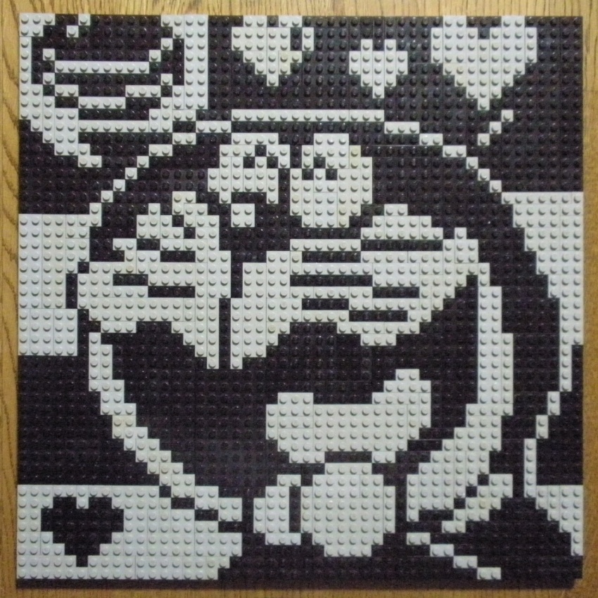 ^_^ closed_eyes doraemon doraemon_(character) heart high_contrast highres lego lego_(medium) monochrome no_humans open_mouth photo_(medium) pixel_art smile solo speech_bubble striped_background tongue unconventional_media you_rei_(blowback)