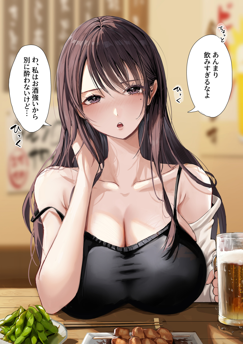 1girl :o absurdres bare_shoulders beer_mug black_camisole blurry blurry_background blush breasts brown_hair camisole cleavage collarbone commentary_request cup edamame enma_daio food hand_in_own_hair highres holding holding_cup huge_breasts long_hair looking_at_viewer mole mole_under_eye mug original restaurant solo speech_bubble straight_hair strap_slip translated very_long_hair yakitori