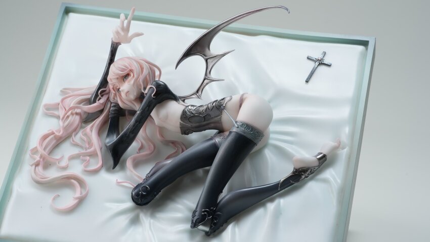 1girl bandages barefoot bat_wings bed_sheet black_thighhighs breasts corset cross figure figure_(medium) garter_belt grey_hair highres long_hair lying original photo_(medium) pink_hair pqstudio2022 restrained small_breasts solo thighhighs wavy_hair wings