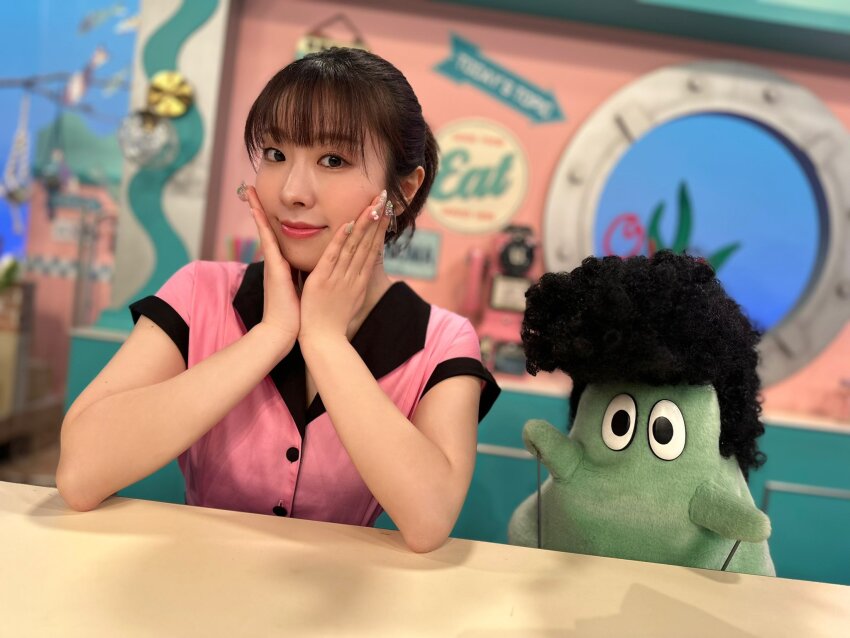1girl blurry blurry_background dress earrings furihata_ai hands_on_own_cheeks hands_on_own_face highres indoors jewelry looking_at_viewer nail_polish photo_(medium) pink_dress puppet real_life short_hair sitting table voice_actor