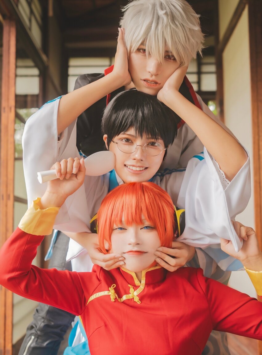 1girl 2boys absurdres aburanaka_tane arms_up black_hair blue_eyes blunt_bangs brown_eyes bun_cover cheek_pinching cheek_pull cheek_squash chin_rest chinese_clothes comb commentary_request cosplay cosplay_photo double_bun emoemocos gintama glasses grin hair_bun hands_on_another&#039;s_cheeks hands_on_another&#039;s_face hands_up head_on_head head_rest highres holding holding_comb indoors japanese_clothes kagura_(gintama) kagura_(gintama)_(cosplay) kimono lips long_sleeves looking_at_viewer multiple_boys orange_hair parted_lips photo_(medium) photoshop_(medium) pinching red_eyes sakata_gintoki sakata_gintoki_(cosplay) shimura_shinpachi shimura_shinpachi_(cosplay) short_hair smile tangzhuang teeth white_hair wide_sleeves yusura_uni