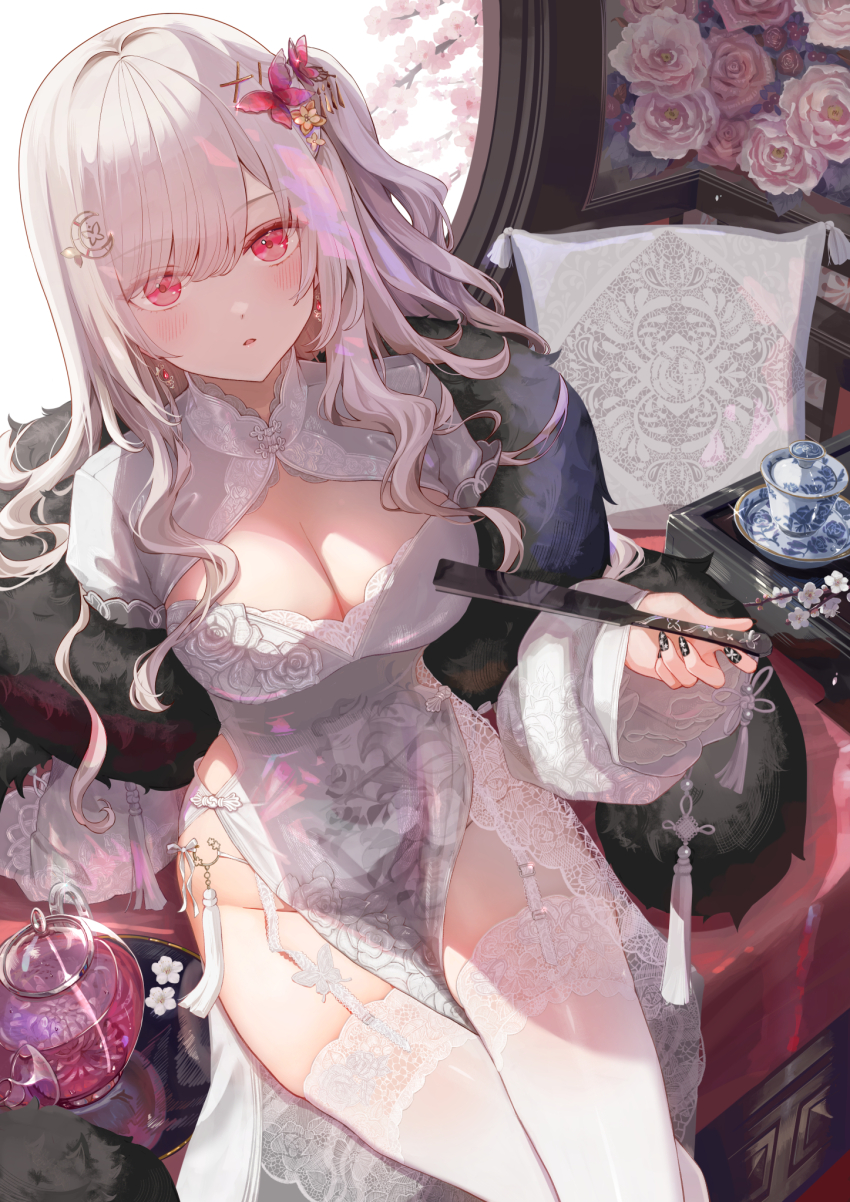 1girl black_nails blush breasts butterfly_hair_ornament cleavage cleavage_cutout clothing_cutout commentary dress english_commentary fingernails flower folded_fan folding_fan fur_trim garter_straps hair_ornament hand_fan hands_up highres holding holding_fan ito_lab lace lace-trimmed_thighhighs lace_trim large_breasts long_hair long_sleeves looking_at_viewer nail_art nail_polish original parted_lips pelvic_curtain pillow pink_flower red_eyes saucer side_slit sitting solo striped_clothes teapot thighhighs vertical-striped_clothes white_dress white_garter_straps white_hair white_thighhighs