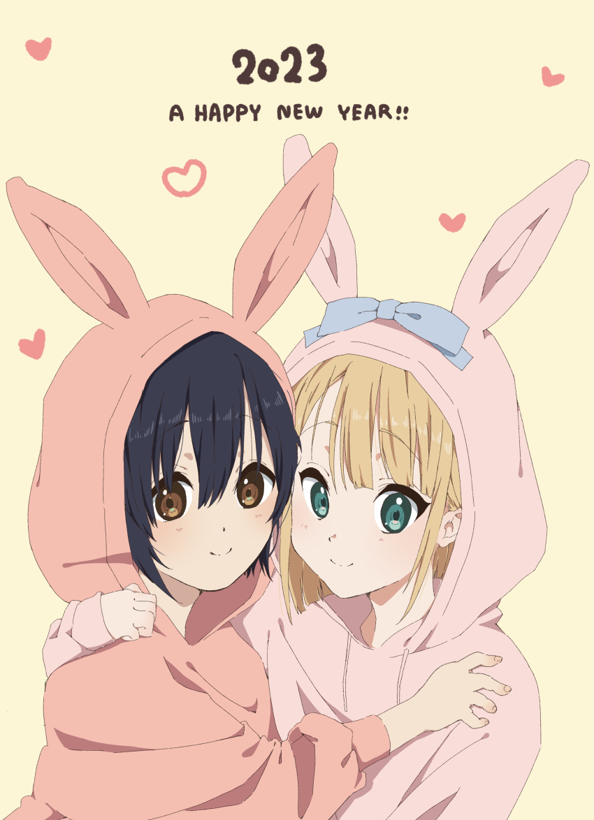 2023 22/7 2girls absurdres animal_hood blonde_hair blue_bow blue_hair bow brown_eyes closed_mouth dark_blue_hair green_eyes happy_new_year heart highres hood hoodie hug looking_at_viewer multiple_girls new_year pink_hoodie rabbit_hood saito_nicole short_hair simple_background smile takigawa_miu tanpaku_(oqu_2) upper_body yellow_background