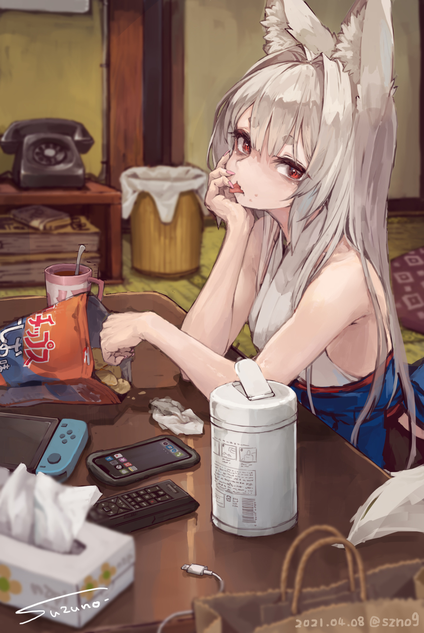 1girl :p animal_ear_fluff animal_ears artist_name bare_arms bare_shoulders blurry blurry_foreground cellphone chips_(food) commentary controller cup dated depth_of_field fingernails food food_on_face hand_on_own_cheek hand_on_own_face head_rest highres japanese_clothes kimono long_hair looking_at_viewer nail_polish nintendo_switch original phone pink_nails potato_chips red_eyes remote_control short_eyebrows sideways_glance signature sleeveless sleeveless_kimono smartphone solo suzuno_(bookshelf) symbol-only_commentary table thick_eyebrows tissue_box tongue tongue_out twitter_username used_tissue white_hair white_kimono