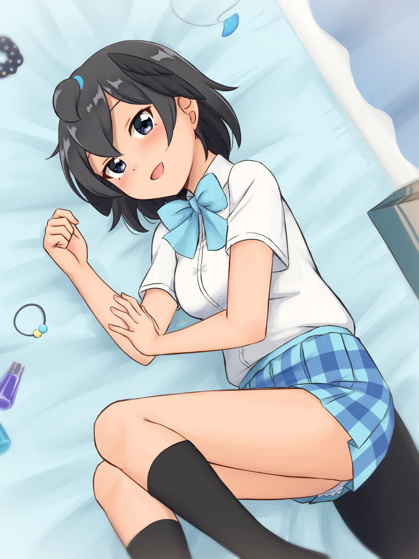 1girl :d absurdres alternate_costume black_eyes black_hair black_socks blue_bow blue_bowtie blue_skirt blush bow bowtie commentary feet_out_of_frame head_wings highres indoors jewelry kemono_friends kneehighs looking_at_viewer lying on_bed on_side open_mouth pendant pendant_removed plaid_clothes plaid_skirt pleated_skirt school_uniform scrunchie shiraha_maru shirt short_hair short_sleeves skirt smile socks solo superb_bird-of-paradise_(kemono_friends) tail unworn_scrunchie white_shirt wings