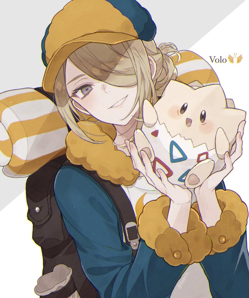1boy backpack bad_id bad_twitter_id bag blonde_hair blue_coat coat gen_2_pokemon grey_eyes hair_bun hair_over_one_eye hat highres long_sleeves looking_at_viewer nintendo one_eye_covered pokemon pokemon_legends:_arceus satsuki_(miicat) single_hair_bun smile togepi volo_(pokemon) white_background