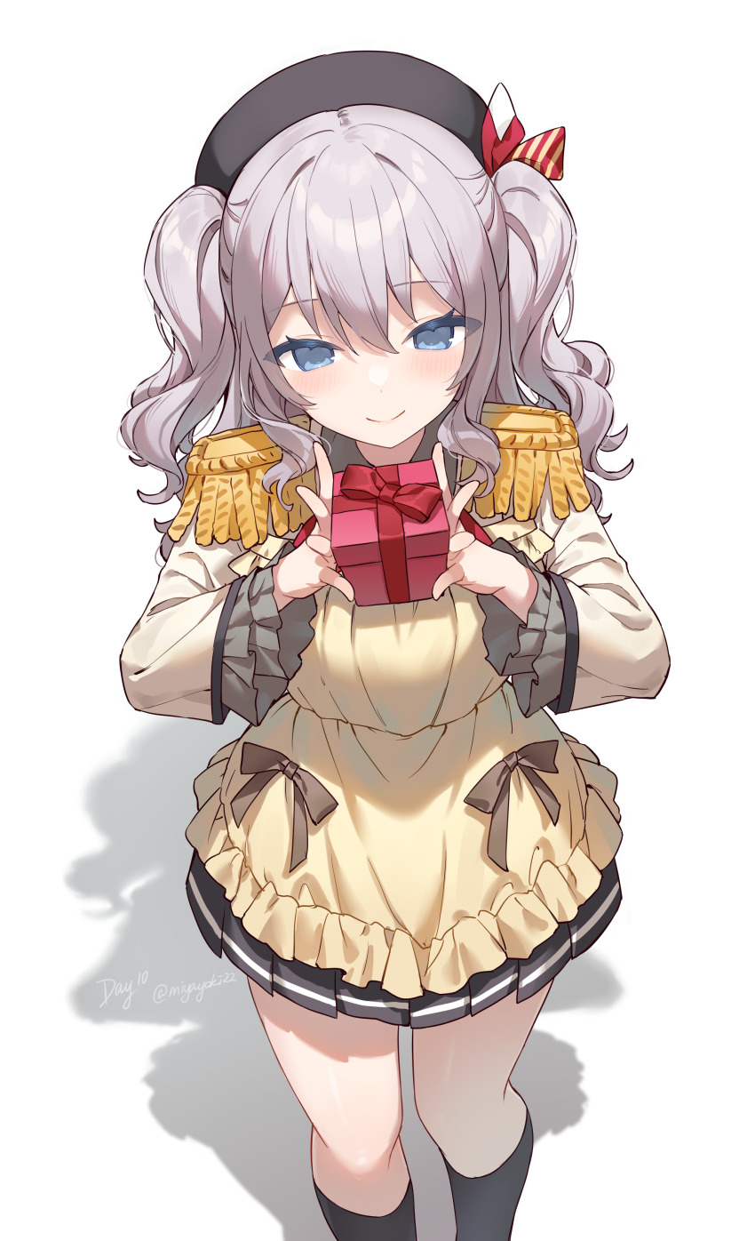 1girl absurdres apron black_hat black_skirt black_socks blue_eyes brown_ribbon closed_mouth commentary frilled_sleeves frills gift grey_hair hat highres holding holding_gift jacket kantai_collection kashima_(kancolle) military_jacket miyayoki pleated_skirt red_ribbon ribbon shadow short_twintails simple_background skirt smile socks solo standing twintails twitter_username wavy_hair white_background wrapped_up yellow_apron