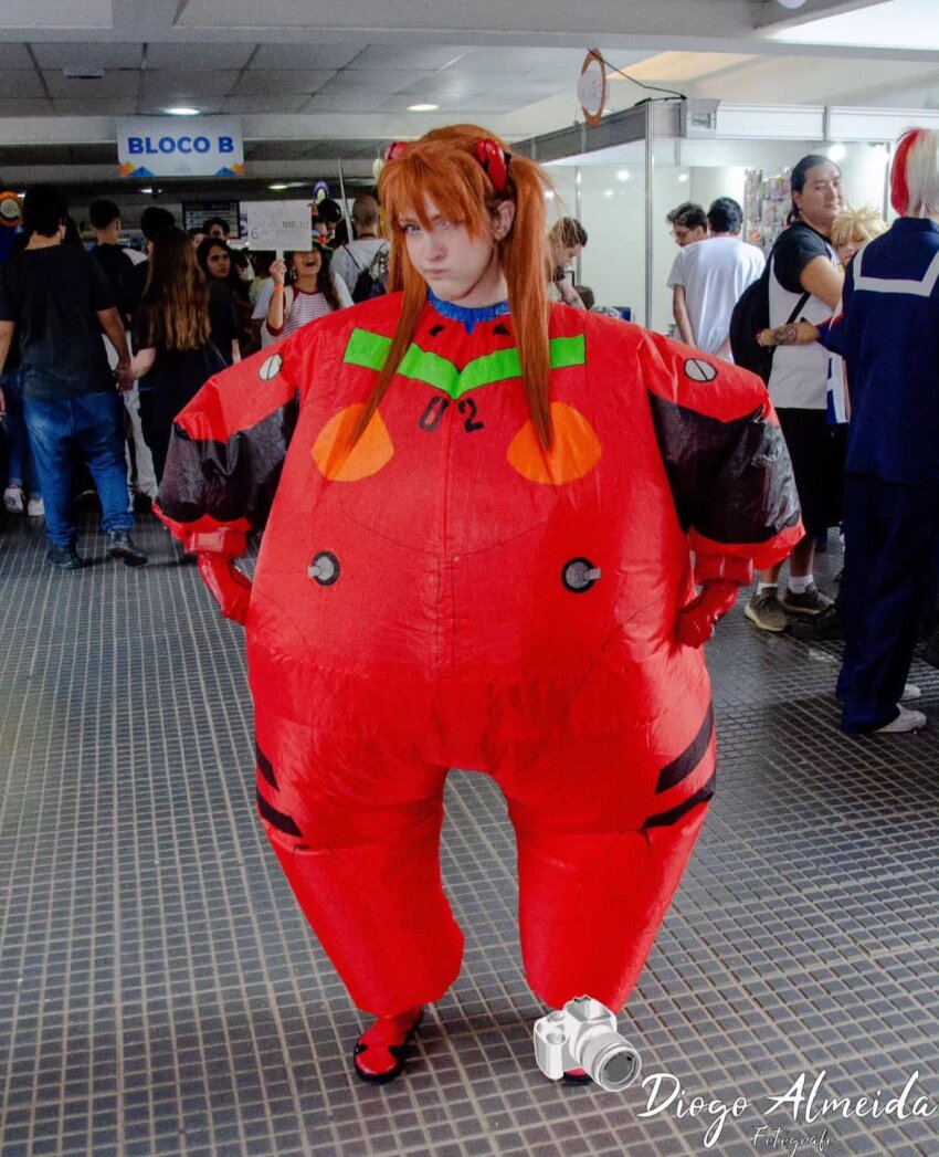 1girl 6+others alternate_costume alternate_form blue_eyes bodysuit brazilian_(nationality) brown_hair cheek_bulge cosplay hand_on_own_hip hands_on_own_hips highres inflation interface_headset_(evangelion) lips mecha_pilot_suit memepantazis multiple_boys multiple_girls multiple_others neon_genesis_evangelion ok_sign photo_(medium) plugsuit_(evangelion) red_bodysuit shiny_clothes smile solo souryuu_asuka_langley souryuu_asuka_langley_(cosplay) standing tsundere two_side_up