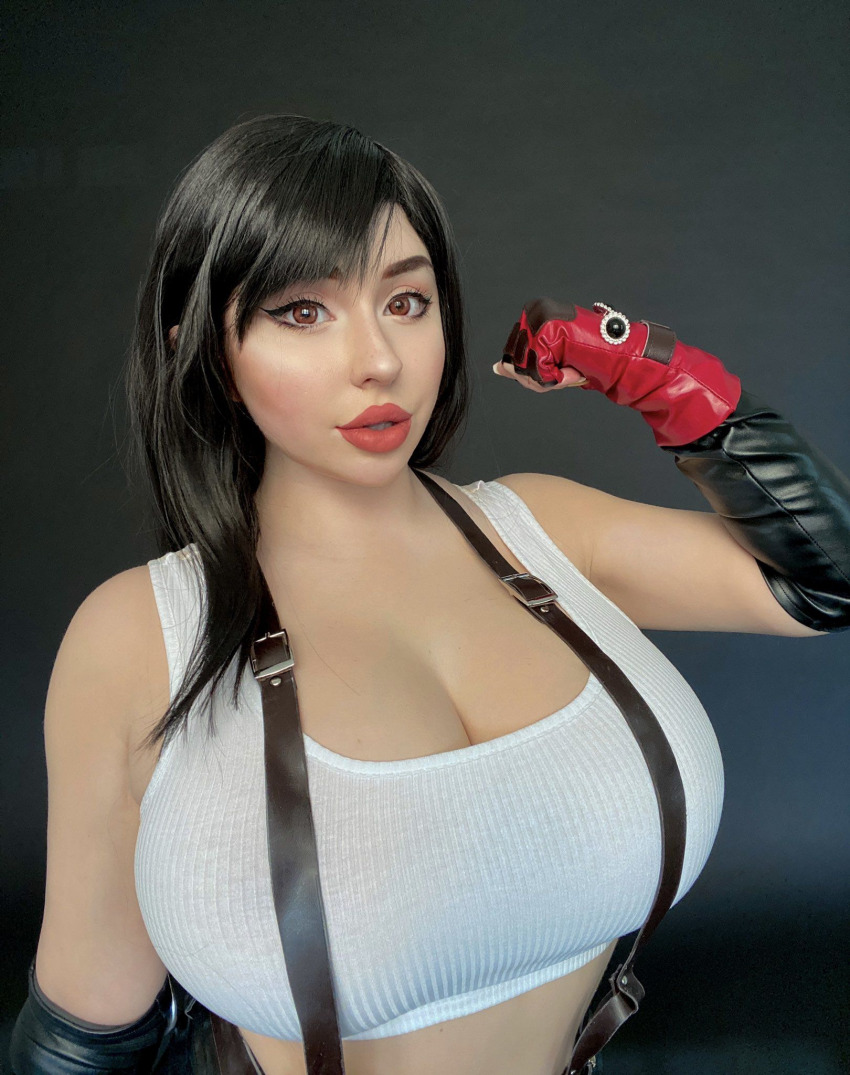 1girl bare_shoulders black_background black_gloves black_hair black_skirt black_suspenders blush_(makeup) breasts brown_eyes cleavage collarbone cosplay cosplay_photo elbow_gloves eyelashes eyeliner female_focus final_fantasy final_fantasy_vii fingerless_gloves gloves highres large_breasts lips lipstick long_hair makeup open_mouth photo_(medium) red_gloves red_lips skirt solo source_request square_enix square_soft suspenders tagme tank_top teeth thejulietttemichele tifa_lockhart tifa_lockhart_(cosplay) white_top wig