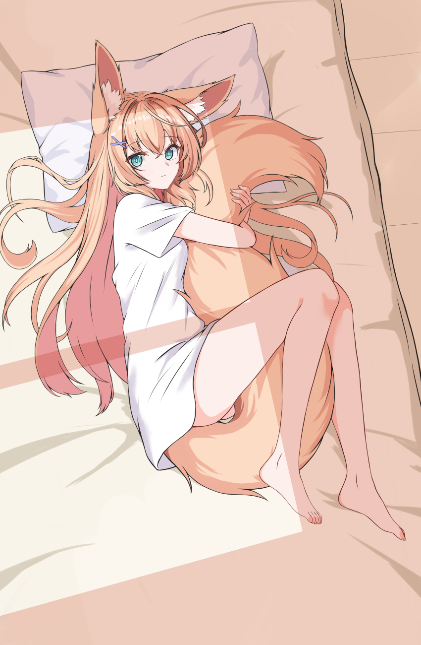 1girl absurdres animal_ears barefoot blonde_hair blue_eyes fetal_position fox_ears fox_girl fox_tail full_body futon head_on_pillow highres hugging_own_tail hugging_tail light_smile long_hair looking_at_viewer lying naked_shirt on_side original pillow shirt short_sleeves tail white_shirt ze_zhi_ai