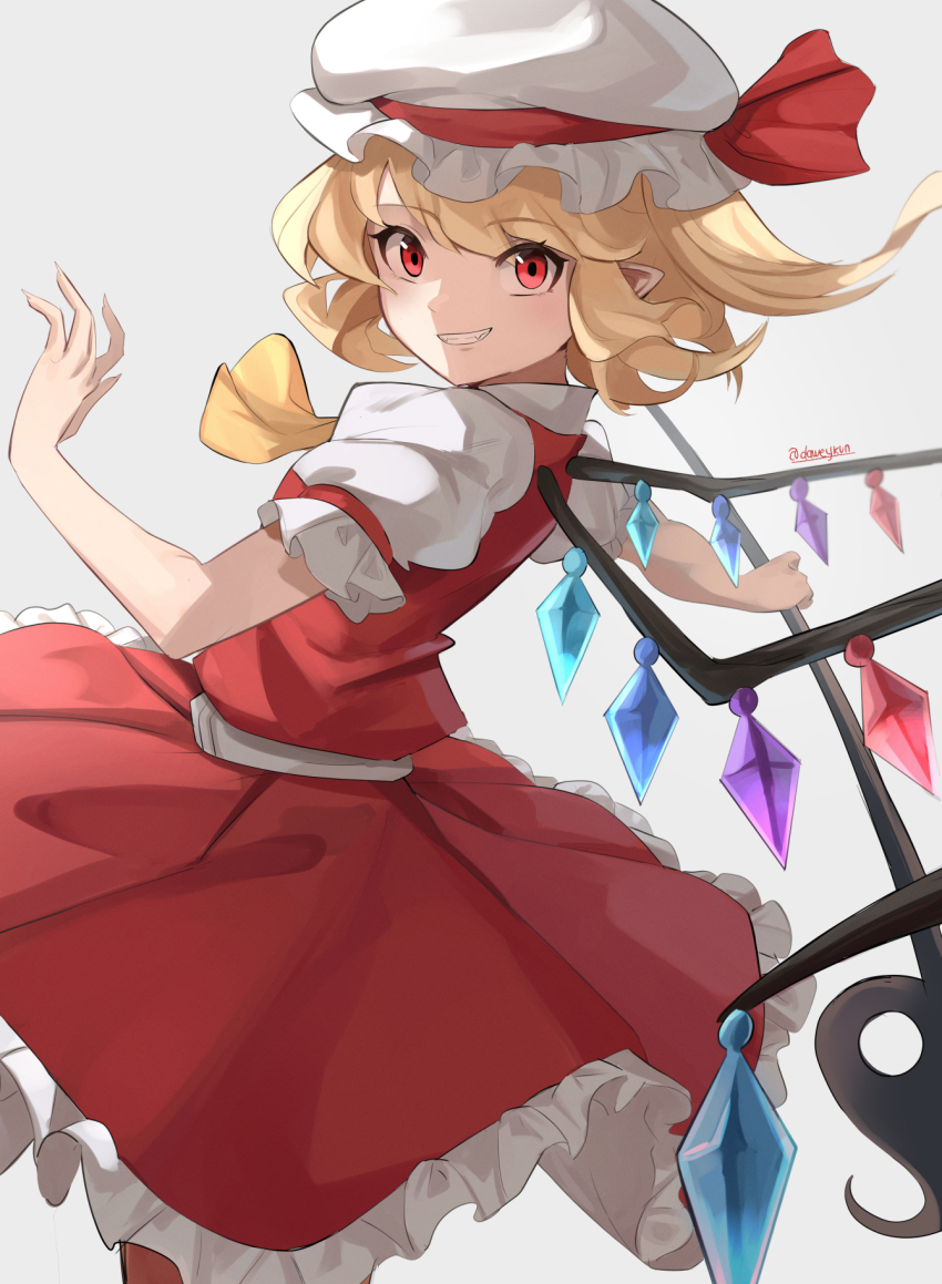 1girl blonde_hair commentary crystal daweykun english_commentary fingernails flandre_scarlet frilled_skirt frills grey_background grin hat highres laevatein_(touhou) long_fingernails long_hair mob_cap pointy_ears red_eyes red_skirt red_vest sharp_fingernails side_ponytail simple_background skirt smile solo touhou twitter_username vest white_hat wings